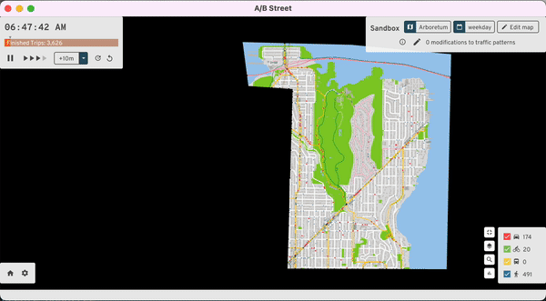 Screencast of the A/B
Street travel simulator, showing an overhead street map view, roughly centered
around the Washington Park Arboretum, with hundreds of dots sliding along the
streets. An adjustable playback speed is shown, panning and zooming in reveals
the moving dots are cartoon people and vehicles getting around the streets of
Seattle. Madison Ave looks busy.